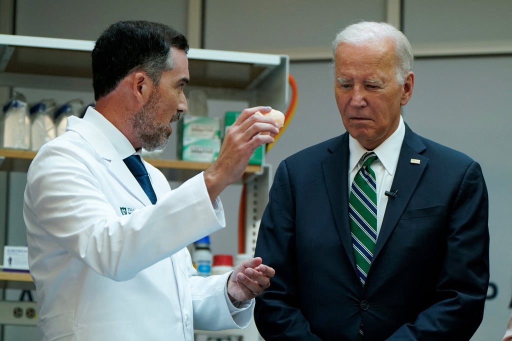 US President Joe Biden (right) listens to Quincy Brown, Associate Professor of Biomedical Engineering at Tulane University, in New Orleans, Louisiana, on Tuesday. Photo: Reuters