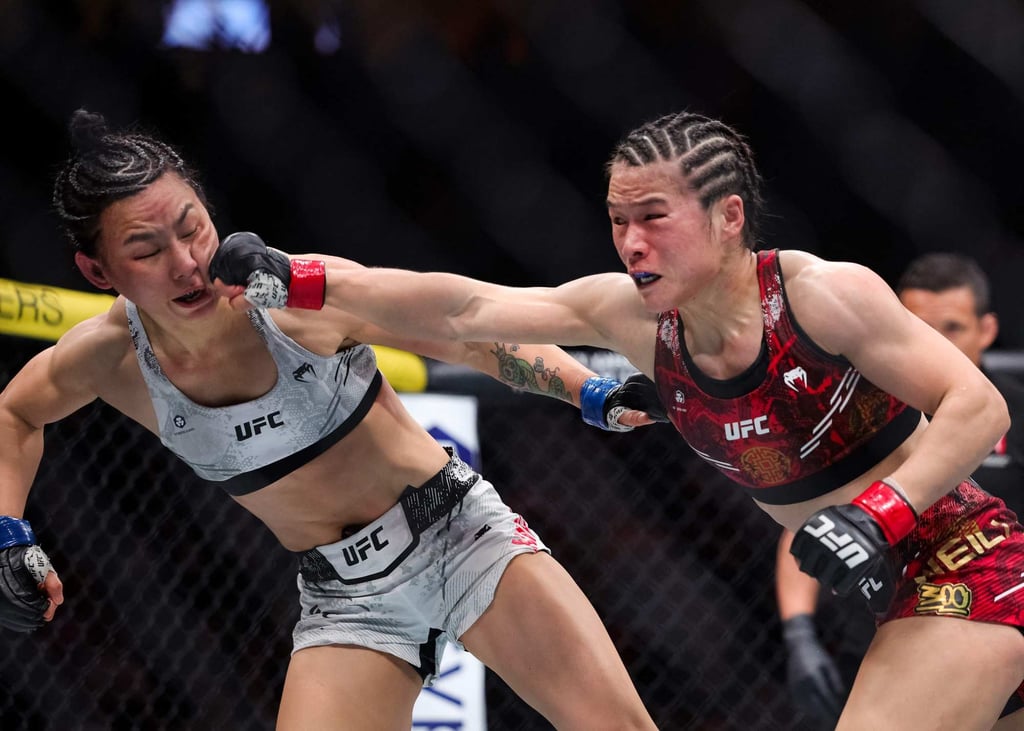 UFC’s rise in popularity has produced the sport’s first Chinese champion in Zhang Weili (right, in action against compatriot Yan Xiaonan). Photo: AFP