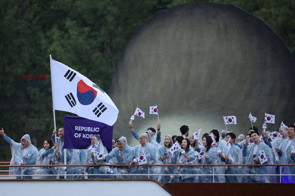 Athletes of South Korea aboard a boat in the floating parade on the river Seine during the opening ceremony of the 2024 Olympics in Paris on July 26. The team was mistakenly introduced as North Korea. Photo: Reuters