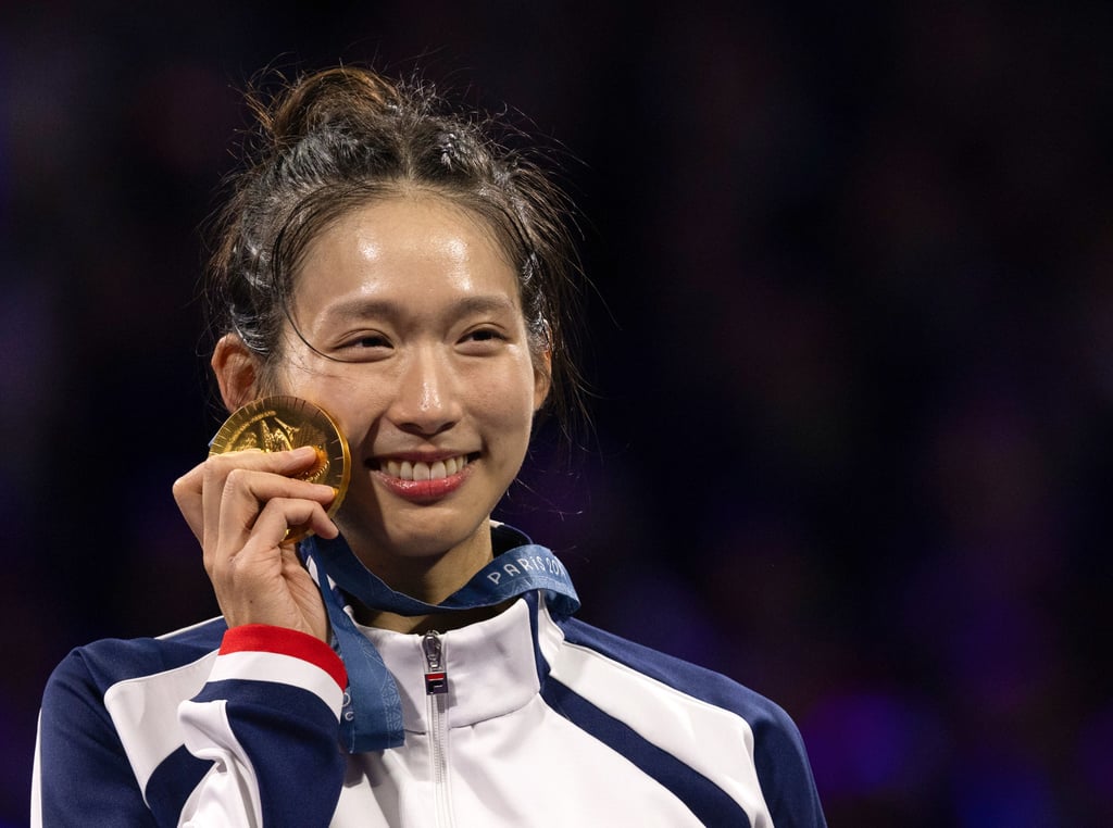 Hong Kong fencer Vivian Kong clutches her gold medal at the Games. Photo: DeFodi Images via Getty Images