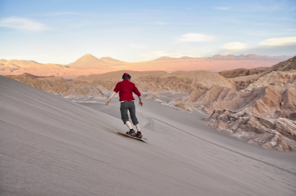 A snowboarder rides down a dune in Chile’s Atacama Desert. Photo: Shutterstock A snowboarder rides down a dune in Chile’s Atacama Desert. Photo: Shutterstock