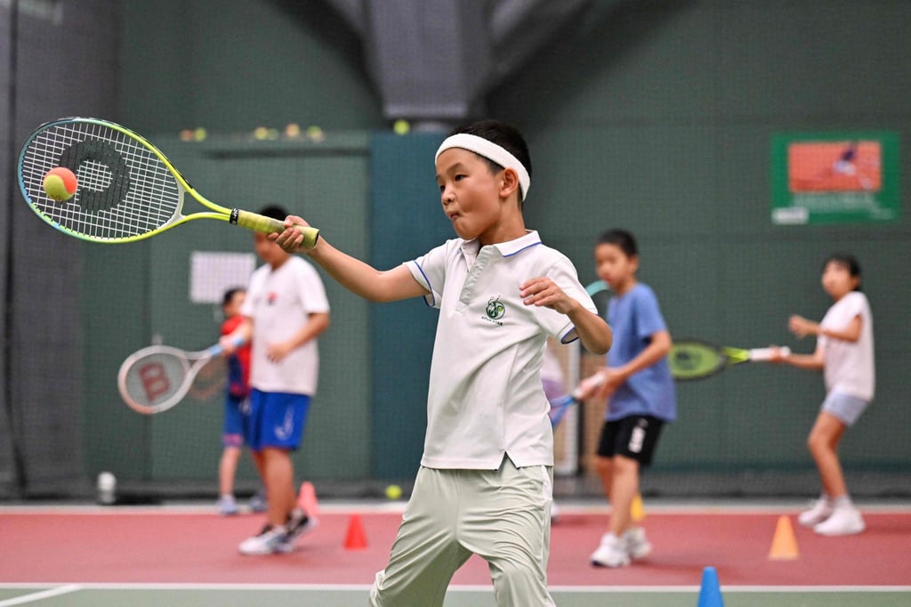 Children practise tennis in Beijing, where clubs have reported a rise in interest since the Olympics. Photo: AFP