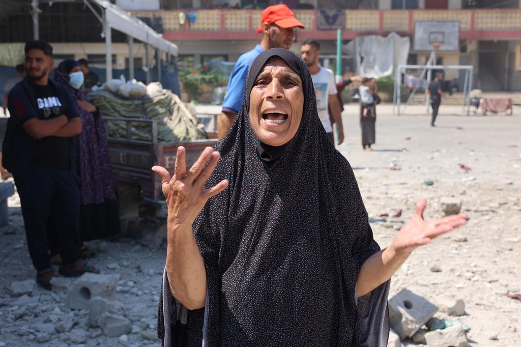 A woman reacts after an Israeli strike on a school. Photo: AFP