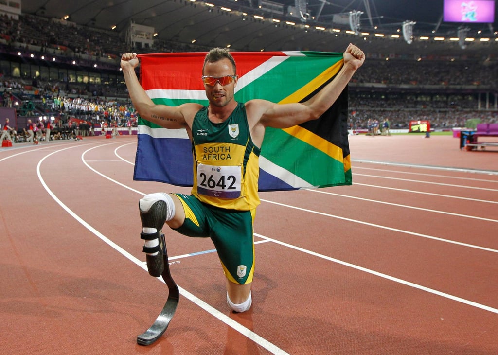 Oscar Pistorius with the South African flag after he won the 400m – T44 final at the London 2012 Paralympics. Photo: AFP