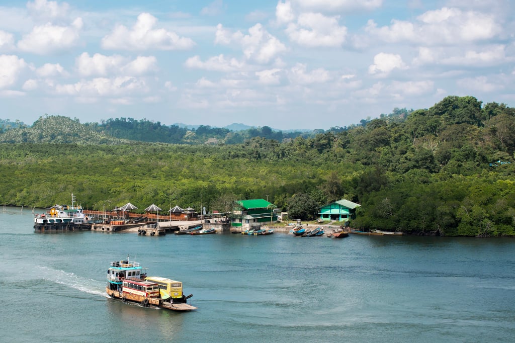 A vehicular ferry (front) carries two buses on a river in Middle Andaman. Photo: Avantika Chaturvedi