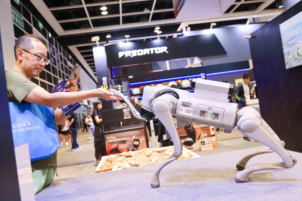 People interact with a robot dog at the fair. Photo: Jelly Tse