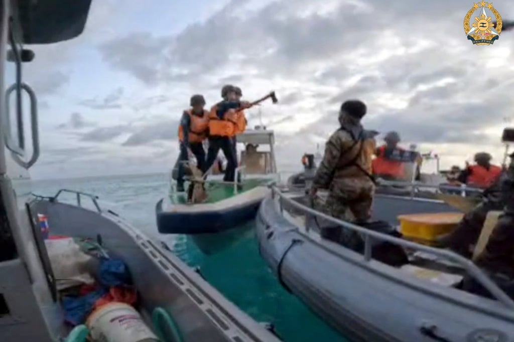 Armed Chinese coastguard personnel approach Philippine troops on a resupply mission to Second Thomas Shoal in the South China Sea on June 17. Photo: AP