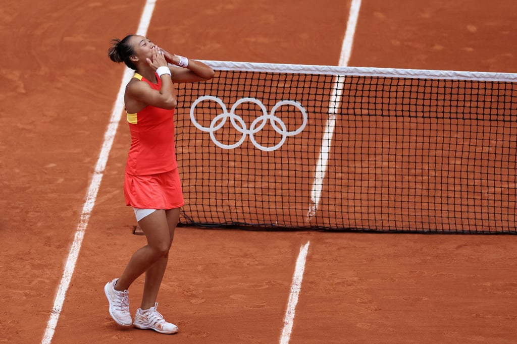 Zheng Qinwen acknowledges the crowd after winning gold at the Paris Olympics. Photo: Reuters