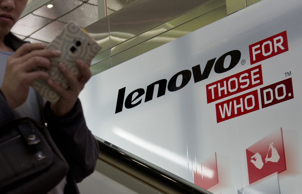 A man walks past an advertising billboard for Chinese technology giant Lenovo. Photo: AFP A man walks past an advertising billboard for Chinese technology giant Lenovo. Photo: AFP