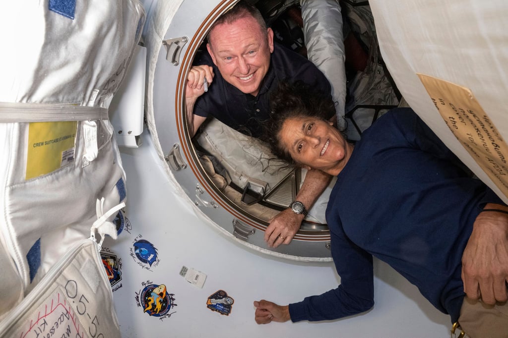 Astronauts Butch Wilmore and Suni Williams pose for a portrait inside the vestibule between the forward port on the International Space Station’s Harmony module and Boeing’s Starliner spacecraft in June. Photo: Nasa via AP