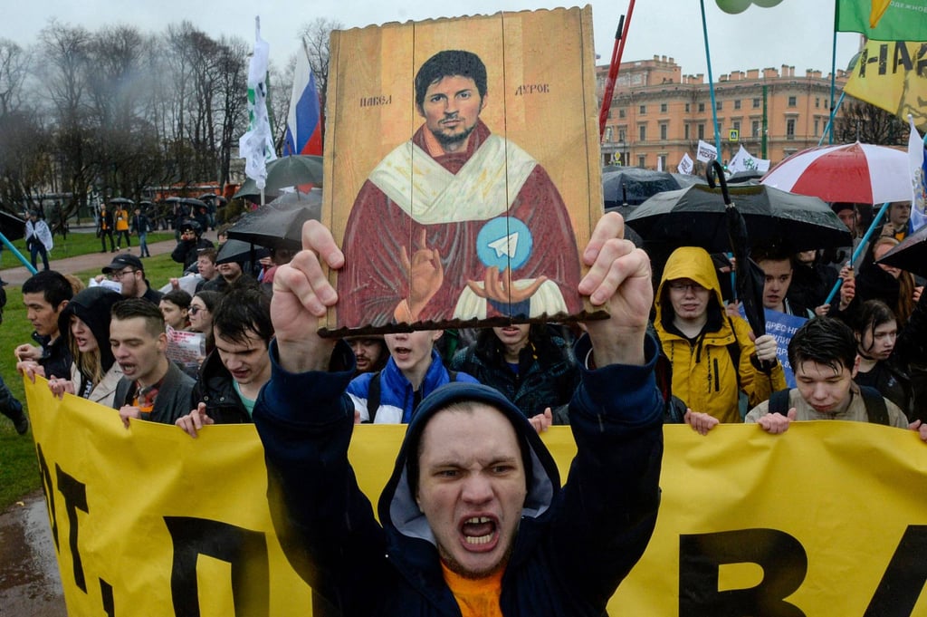 Demonstrators with an icon stylised painting depicting Telegram’s founder Pavel Durov protest against the blocking of the messaging app in Russia, during a May Day rally in Saint Petersburg in 2018. Photo: AFP