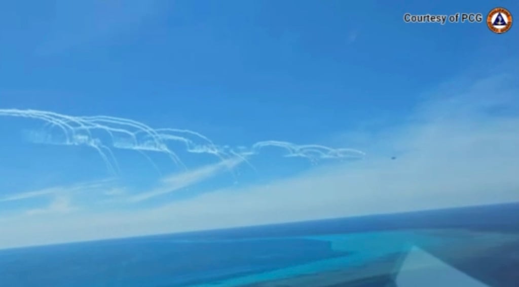 A Chinese air force fighter jet deploys flares near a Philippine BFAR plane near Scarborough Shoal in the South China Sea on August 19. Photo: Philippine Coast Guard/AFP