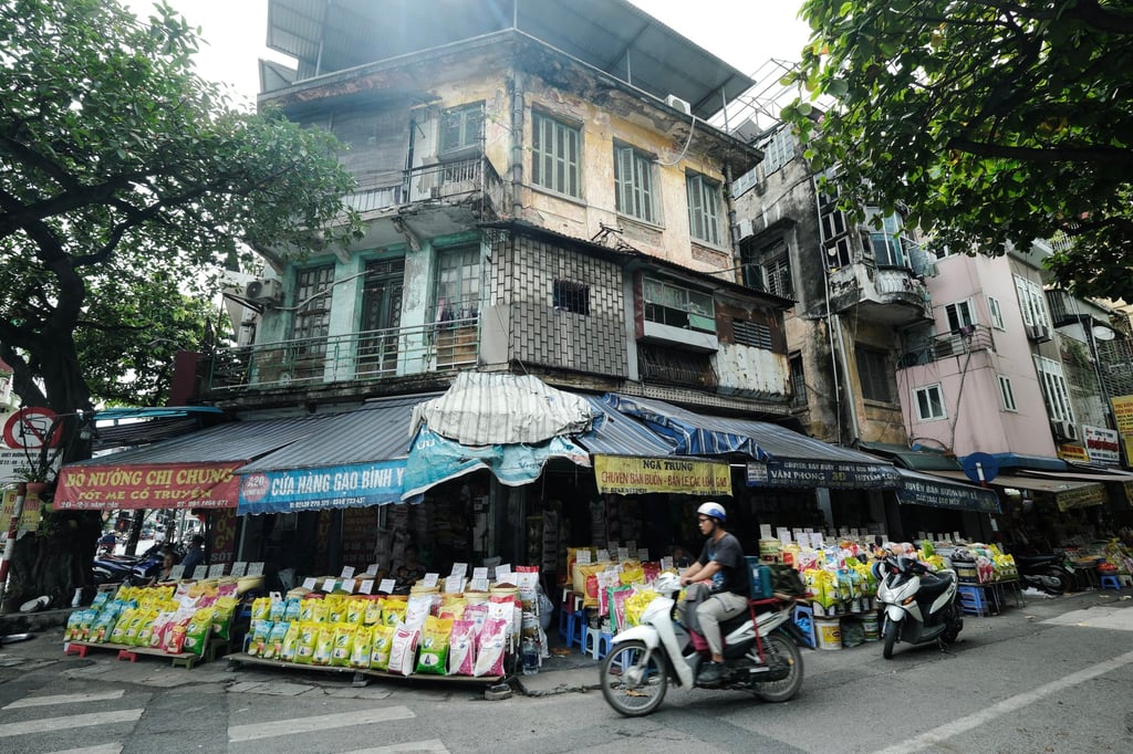 A person rides a motor scooter past a roadside shop selling rice in Hanoi. One of the recently departed officials had unsuccessfully urged the US to grant Vietnam market economy status earlier this year. Photo: EPA-EFE