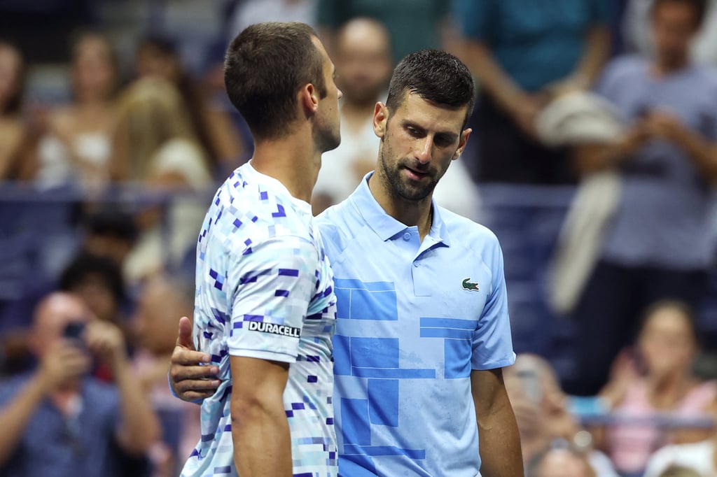 Novak Djokovic consoles compatriot Laslo Djere, who was forced to retire during the third set of their third-round match. Photo: AFP