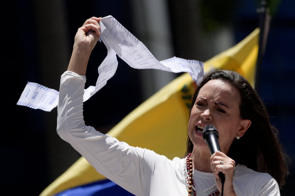 Venezuelan opposition leader Maria Corina Machado holds up a copy of electoral records in Caracas. Photo: Reuters