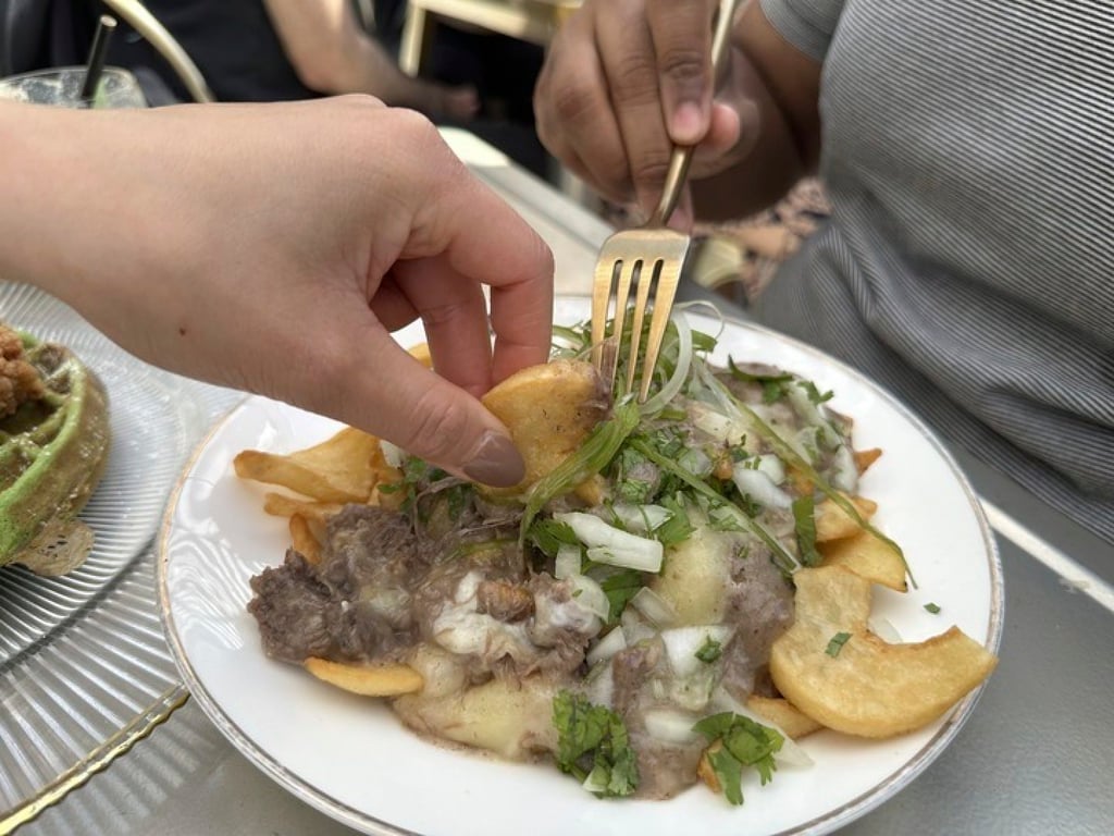 Breaking Dawn’s pho poutine is a fusion dish featuring beef short rib, pho gravy and cheese curds over fries. Photo: AP