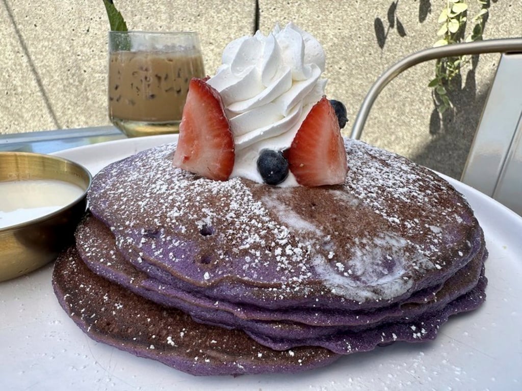 Breaking Dawn’s Ooh BAE Pancakes made with ube (purple yam) and topped with sea salt cream and coconut syrup. Photo: AP