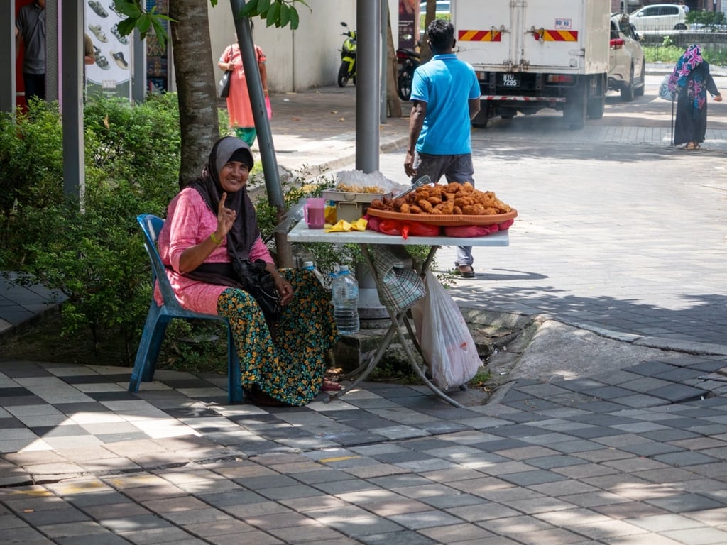 Street vendor Fatimah Abdullah said Kuala Lumpur’s high-speed urbanisation had concreted over swampland. Photo: Hadi Azmi