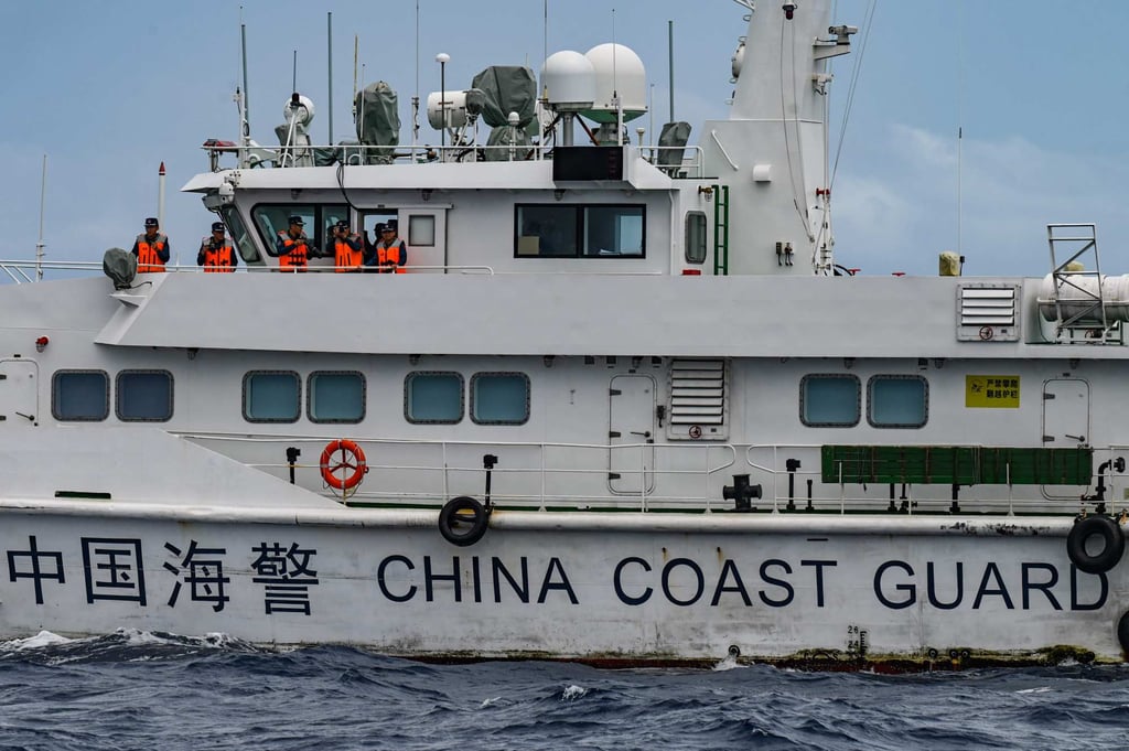 Personnel aboard a Chinese coastguard ship as seen from the Philippine vessel BRP Cabra on Monday. Photo: AFP