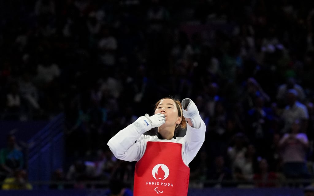 Zakia Khudadadi, who was granted asylum in France, was cheered on like a local throughout the day. Photo: Reuters Zakia Khudadadi, who was granted asylum in France, was cheered on like a local throughout the day. Photo: Reuters