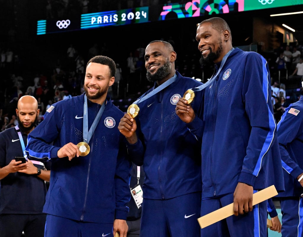 Stephen Curry (left), LeBron James and Kevin Durant after the United States beat France to win Olympic gold. Photo: TNS