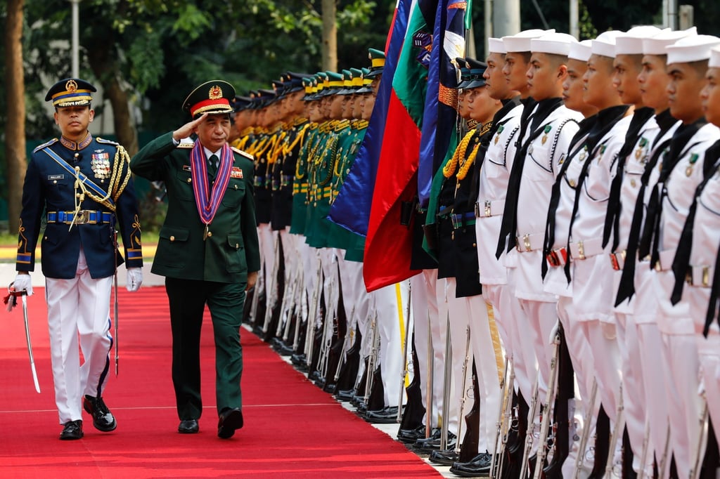 Vietnam’s Defence Minister Phan Van Giang (second from left) salutes Philippines military honour guards at the Department of National Defence in Quezon City on Friday. Photo: EPA-EFE