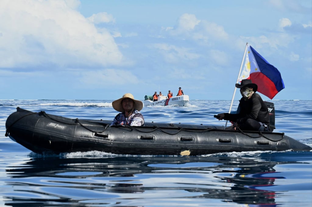 Philippine navy personnel onboard a rigid inflatable boat attempt access to block a Chinese coastguard boat at Second Thomas Shoal in the South China Sea last year. Photo: AFP