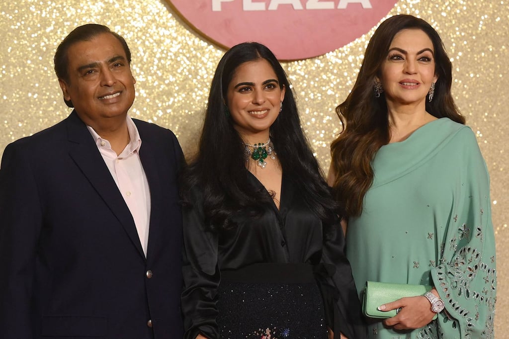 Mukesh Ambani (left) with his wife Nita (right) and daughter Isha (centre). Photo: AFP
