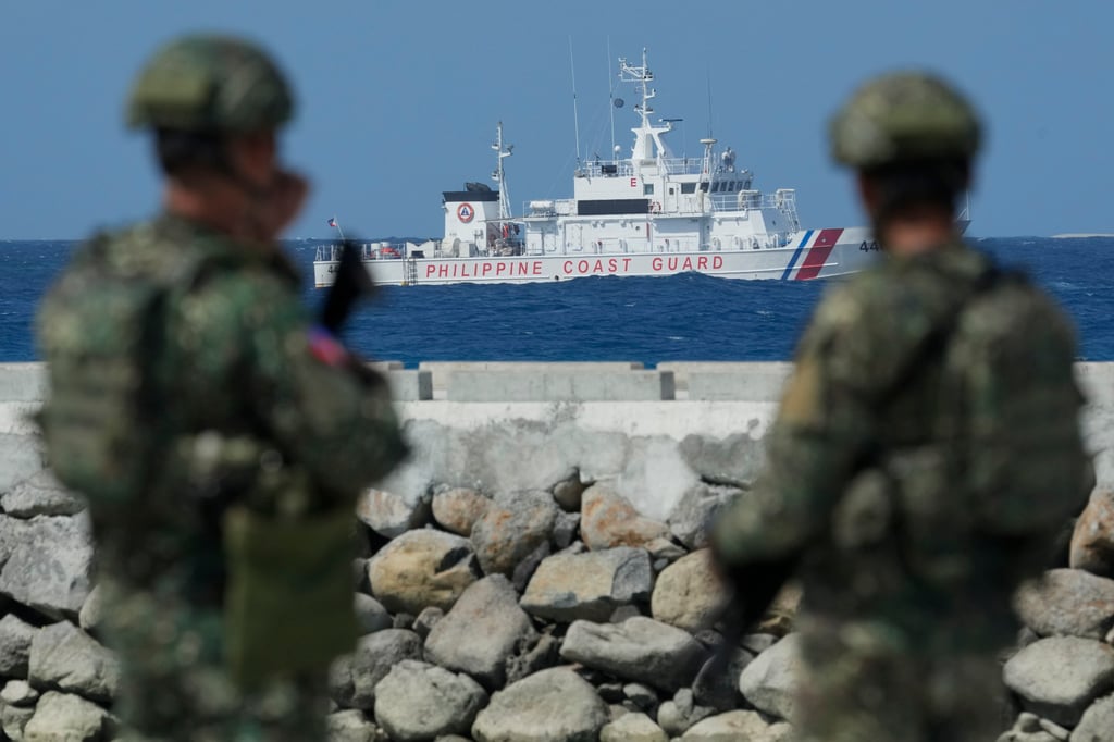 Philippine troops watch a Philippine coastguard ship as they secure an area on Thitu Island, locally called Pag-asa Island, in December 2023. Photo: AP