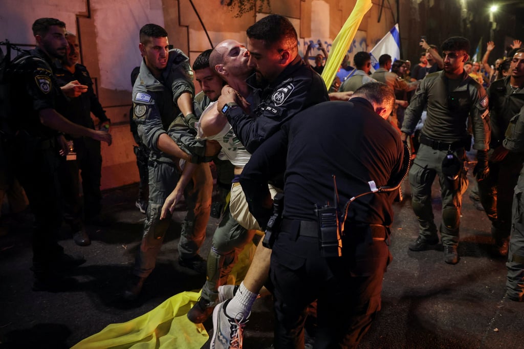 Police detain a protester at an anti-government rally in Tel Aviv, Israel on Sunday. Photo: Reuters