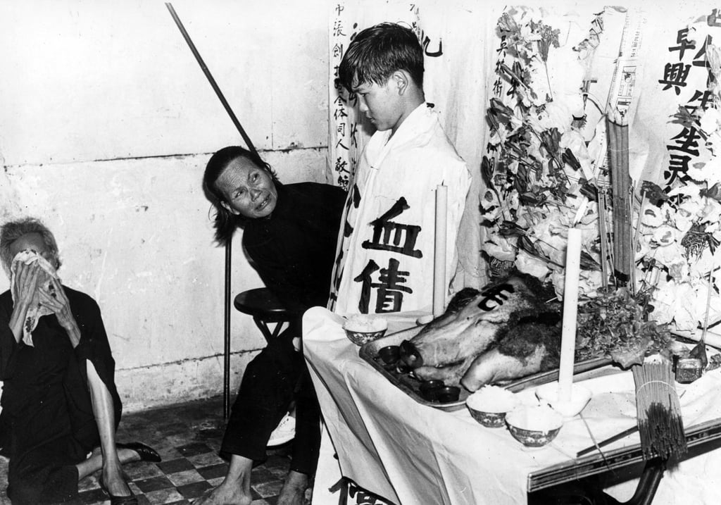 Mrs Tsang with her youngest son Tsang Shing-wan, 6, at a memorial ceremony to mourn her husband and two elder sons in October 1970. Mr Tsang Ngau and the boys, Tsang Bing-nam and Tsang Cho-hing, were abducted and killed by mainland captors while working in their oyster bed at Pak Nai. Photo: SCMP