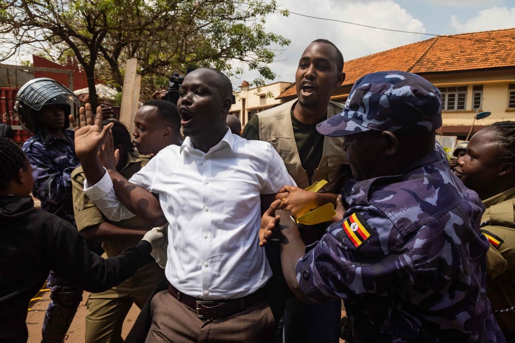 Policemen arrest protesters marching towards Uganda’s parliament during a planned anti-corruption demonstration in July. Photo: AFP Policemen arrest protesters marching towards Uganda’s parliament during a planned anti-corruption demonstration in July. Photo: AFP