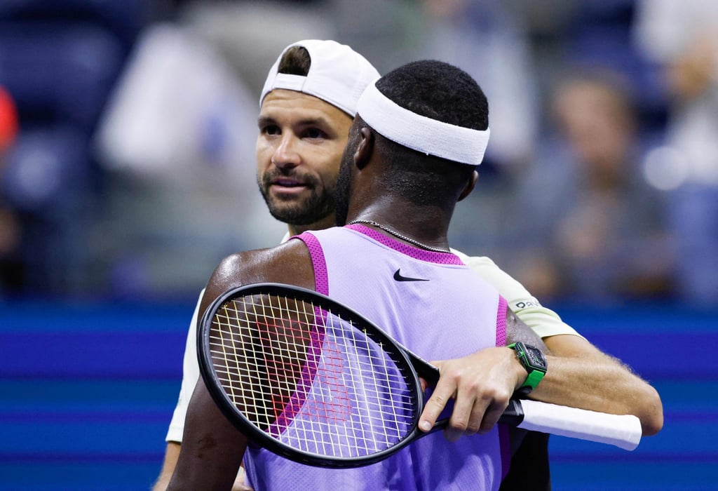 Frances Tiafoe (right) and Grigor Dimitrov hug at the net after the Bulgarian retired injured. Photo: AFP Frances Tiafoe (right) and Grigor Dimitrov hug at the net after the Bulgarian retired injured. Photo: AFP