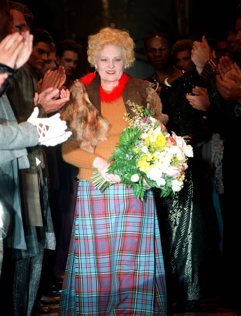British designer Vivienne Westwood receives a standing ovation at the end of the presentation of her men’s collection for autumn/winter 1999-00 in Milan. Photo: AP Photo