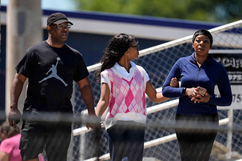 Parents walk their child out of Apalachee High School after a shooting at the school on Wednesday. Photo: AP Parents walk their child out of Apalachee High School after a shooting at the school on Wednesday. Photo: AP