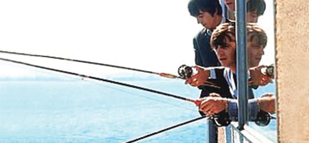 The Beatles fish out of the window of The Edgewater Hotel, in Seattle, in 1964. Photo: TNS The Beatles fish out of the window of The Edgewater Hotel, in Seattle, in 1964. Photo: TNS