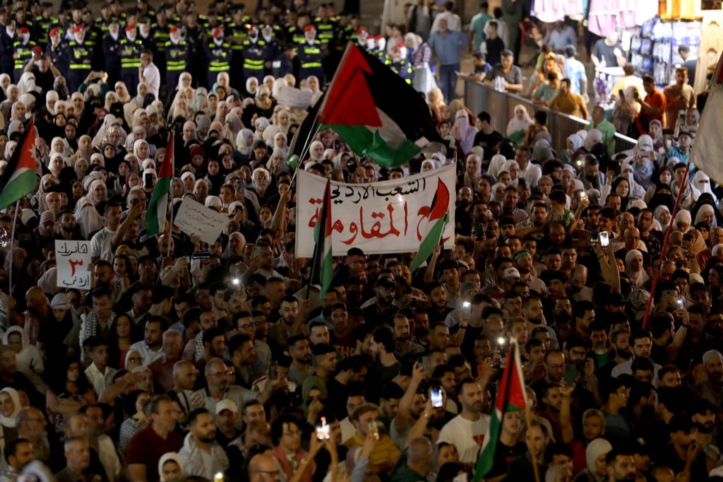 Demonstrators take part in a march in support of Palestinians in Gaza and to salute the slain Jordanian who shot and killed three Israeli civilians, according to the Israeli authorities, at the Allenby Bridge border crossing in the occupied West Bank, in Amman, Jordan on Sunday. Photo: Reuters Demonstrators take part in a march in support of Palestinians in Gaza and to salute the slain Jordanian who shot and killed three Israeli civilians, according to the Israeli authorities, at the Allenby Bridge border crossing in the occupied West Bank, in Amman, Jordan on Sunday. Photo: Reuters