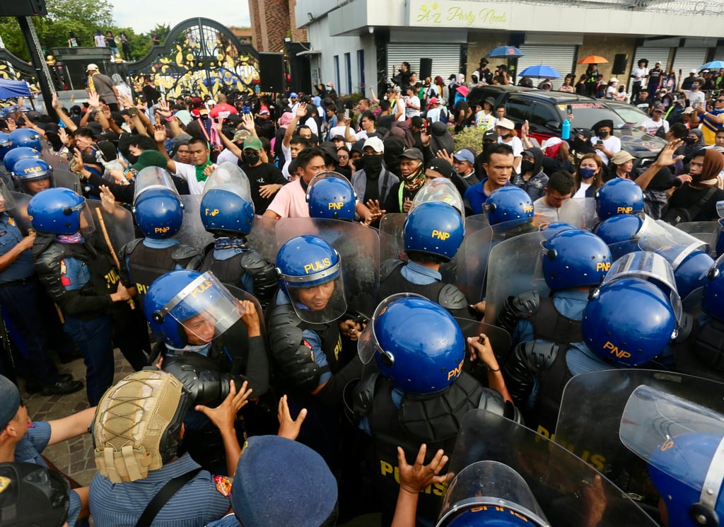 Anti-riot police block supporters of Quiboloy as they stage a protest rally outside the Kingdom of Jesus Christ (KOJC) compound in Davao city, Philippines on August 26. Photo: EPA-EFE Anti-riot police block supporters of Quiboloy as they stage a protest rally outside the Kingdom of Jesus Christ (KOJC) compound in Davao city, Philippines on August 26. Photo: EPA-EFE