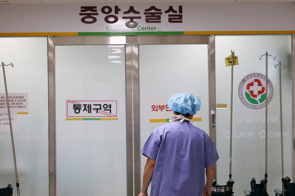 A medical worker enters the operating room at a hospital in Gwangju, South Korea. The strike has strained accident and emergency capacity. Photo: Yonhap via AP