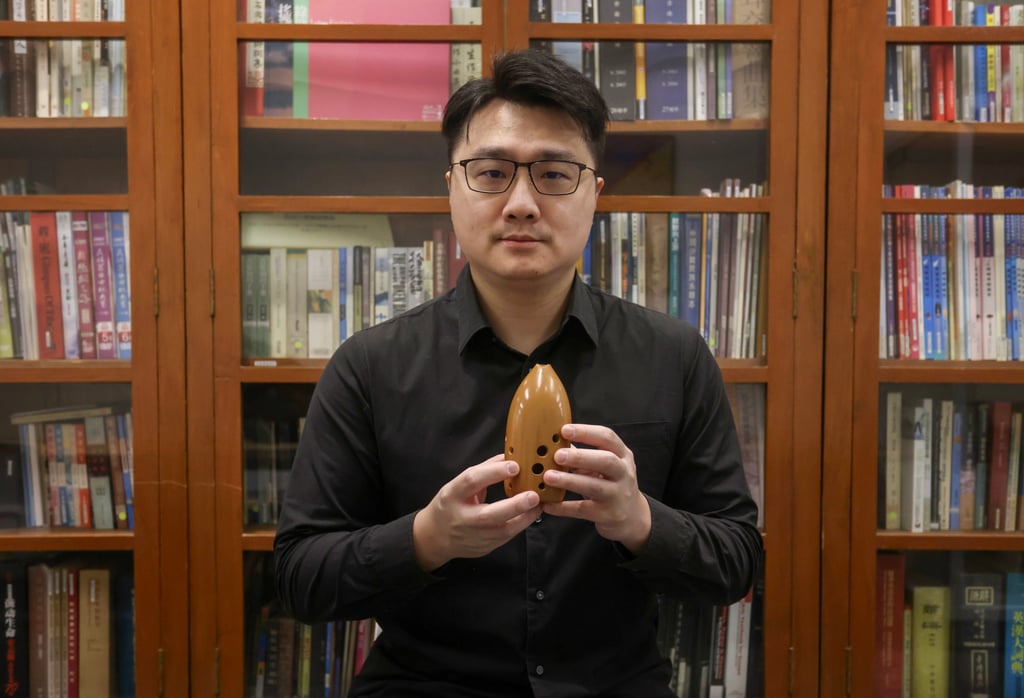 Wu Chih-ting, a Hong Kong Chinese Orchestra member, with a xun. It is the signature clay instrument of modern Chinese orchestras. Photo: Jonathan Wong