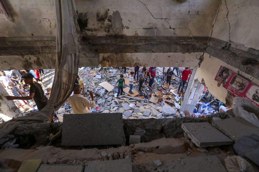 Palestinians inspect the rubble of a destroyed UN-run school-turned-shelter known as al-Jaouni, following an Israeli air strike on Wednesday. Photo: EPA-EFE