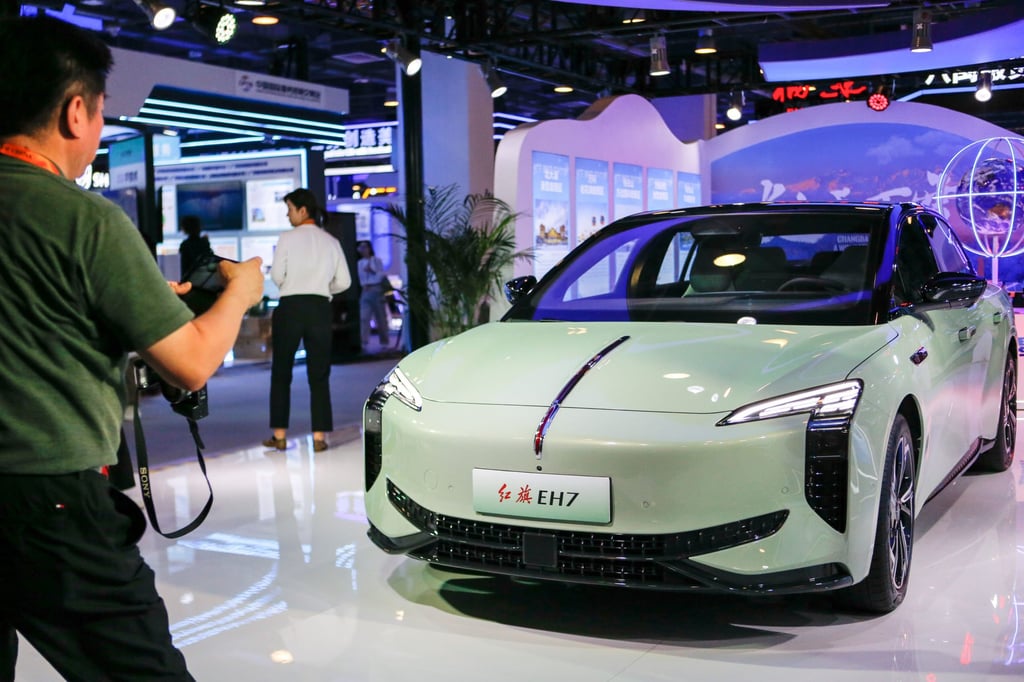 A visitor takes a photo of Chinese luxury carmaker Hongqi’s new EH7 electric vehicle car, which will start sales in Europe this autumn, during the 2024 China International Fair for Trade in Services at the China National Convention Centre in Beijing on September 12, 2024. Photo: Xinhua