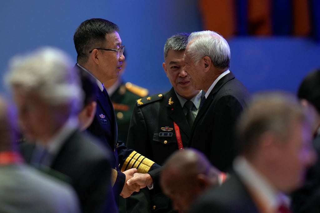 Chinese Defence Minister Dong Jun is greeted by Singapore Defence Minister Ng Eng Hen at the opening of the 11th Xiangshan Forum in Beijing. Dong’s remarks echoed the sentiments of President Xi Jinping, who called in a congratulatory letter to the forum for joint efforts to tackle security challenges arising from global changes of a long-unseen magnitude. Photo: AP