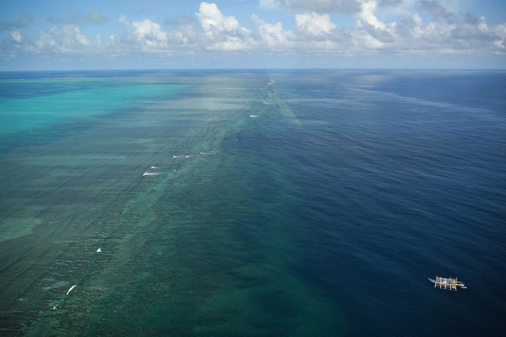 An aerial view of a Philippine fishing boat (bottom R) anchored near a disputed shoal in the South China Sea in 2023. Photo: AFP