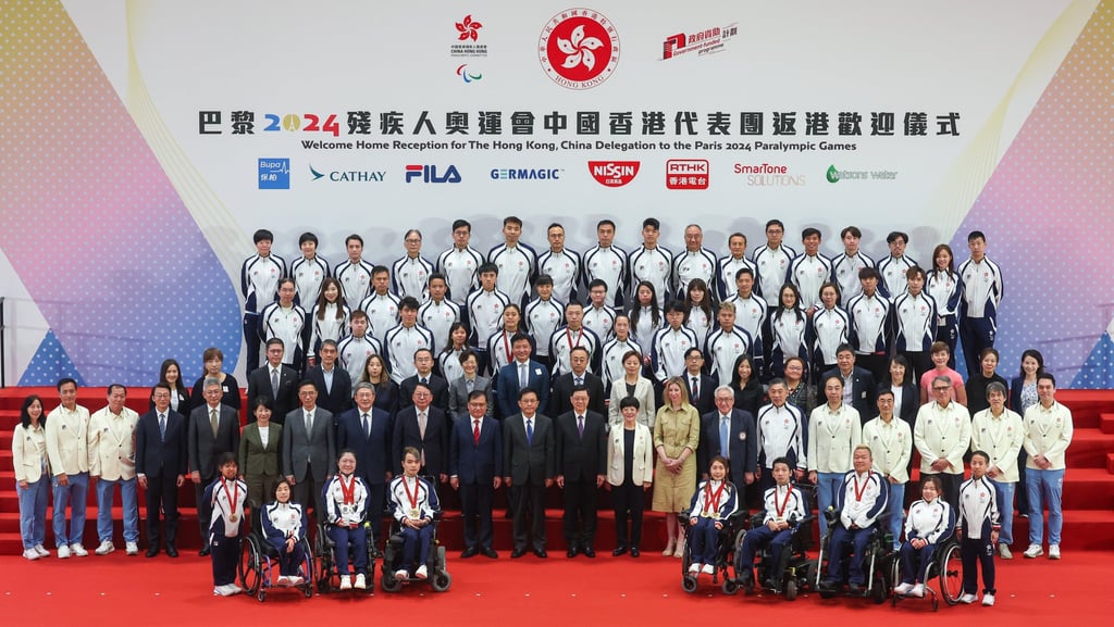 Chief Executive John Lee (centre) alongside Hong Kong’s Paralympic athletes. Photo: Edmond So