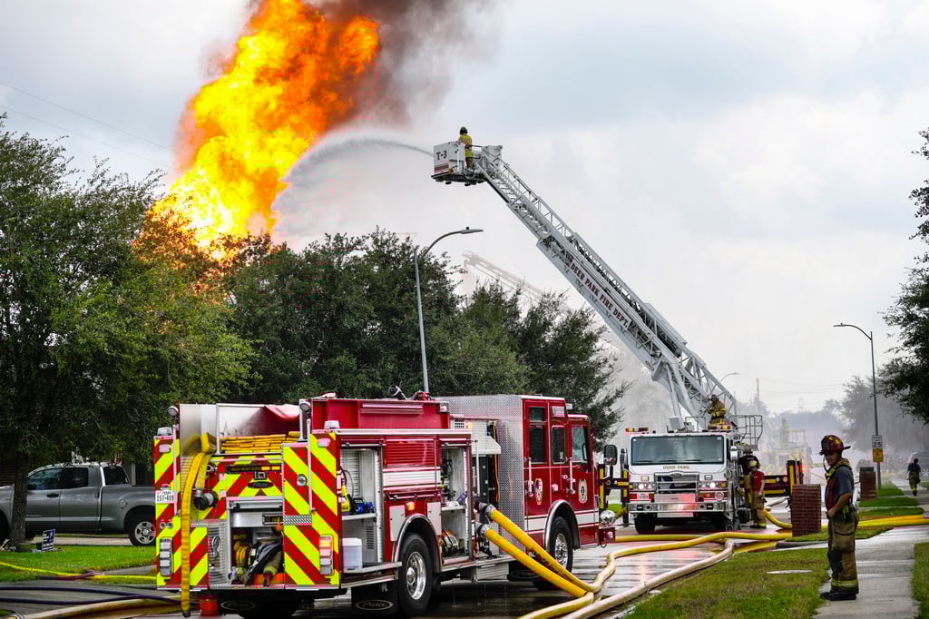Firefighters protect a neighbourhood from a fire in a pipeline carrying liquefied natural gas in La Porte, Texas on Monday. Photo: Houston Chronicle via AP