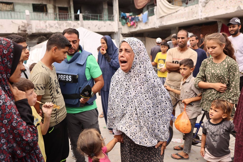 A woman reacts after a school used as shelter by displaced Palestinians was hit by an Israeli strike in the Shujaiya neighbourhood of Gaza. Photo: AFP