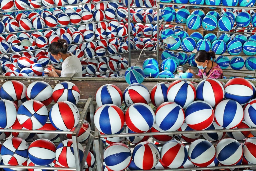 Employees produce basketballs at a factory in eastern China’s Jiangsu province. Photo: AFP Employees produce basketballs at a factory in eastern China’s Jiangsu province. Photo: AFP