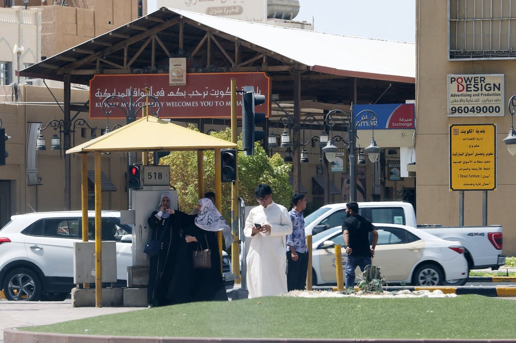 People take shelter from the sun in Kuwait City during summer. Photo: AFP