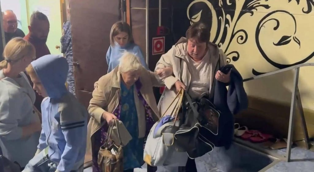 Volunteers assist Russian evacuees from an area targeted by a Ukrainian drone on Saturday. Ukraine says it has successfully struck two Russian weapons depots in the southern Krasnodar and western Tver regions. Photo: Telegram/@opershtab23 via AFP